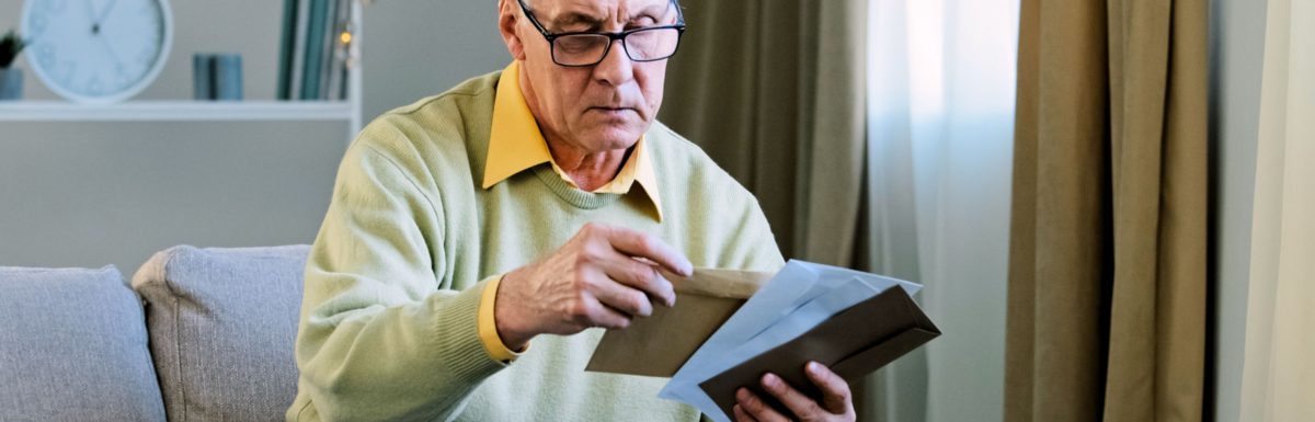 Retiree viewing direct mail.
