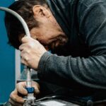 focused technician working with water pump