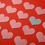 colorful paper hearts on a red background