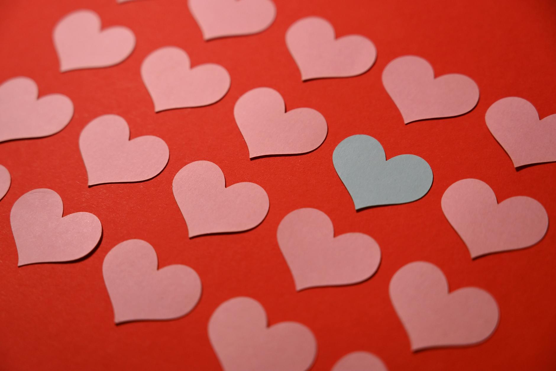 colorful paper hearts on a red background