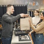 female customers getting paper bags at counter desk