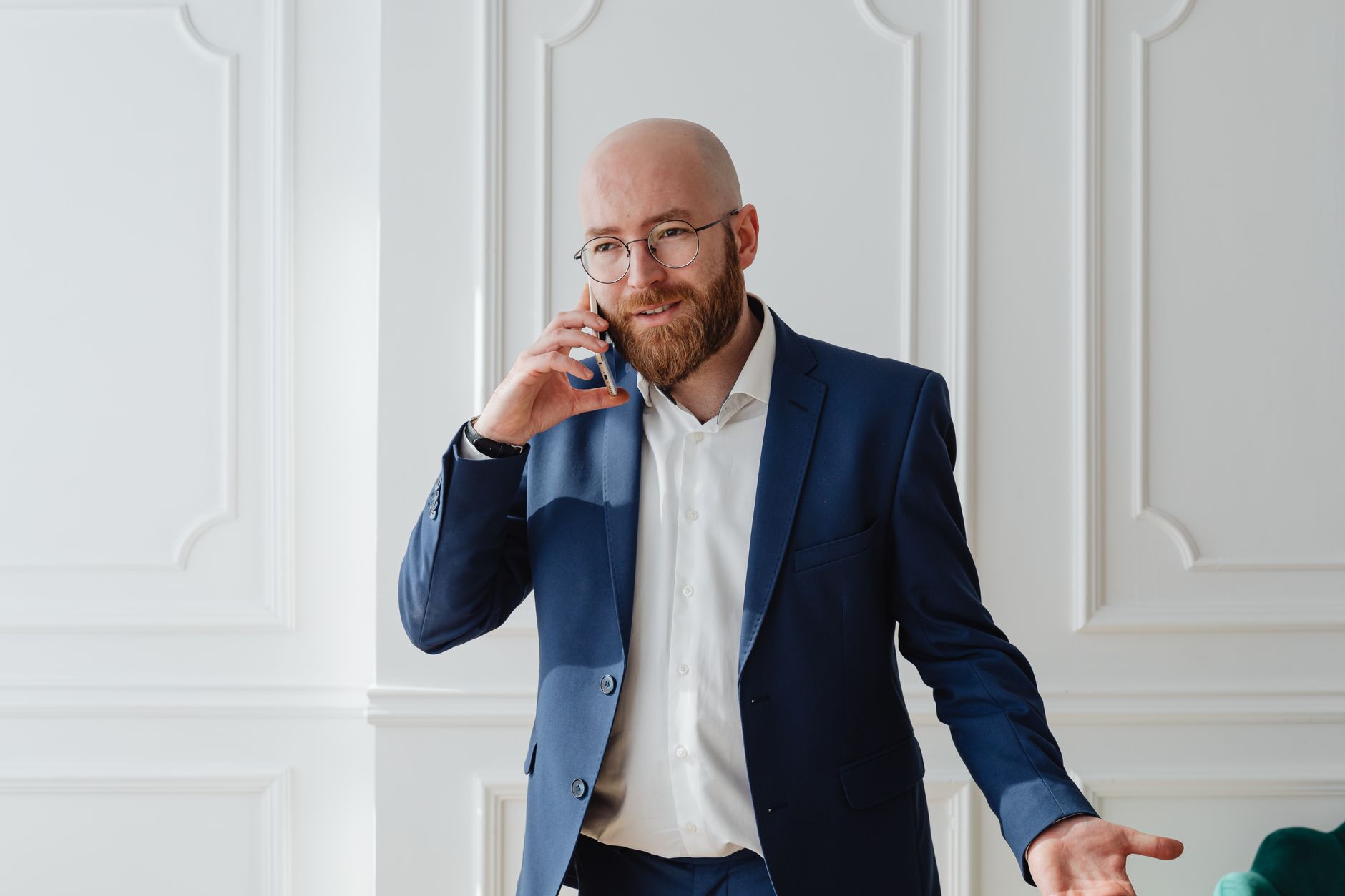 a man in blue suit wearing eyeglasses